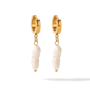 Detailed view of gold hoop earrings with natural baroque freshwater pearl drops.
