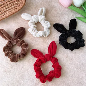 Velvet rabbit ear scrunchies in white, brown, black, and red for autumn hair styling
