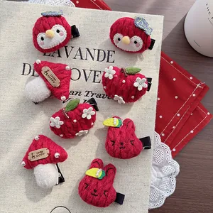 Detail of red knit children hair clips with cute mushroom and animal characters