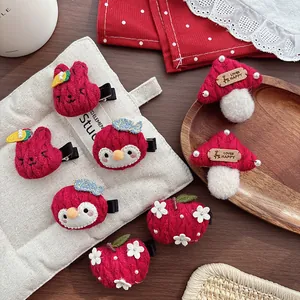 Cute red knitted hair clips featuring rabbit, penguin, and mushroom designs for girls