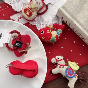 Detail of red festive hair accessories with embroidery and cute cotton-filled designs