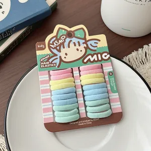 Close-up of pastel kids elastic hair ties in a cute macaron set on a paper display card