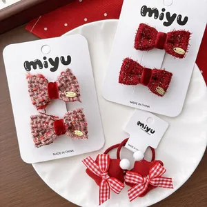 Detail of red tweed bow hair clips and star hair ties with metallic handmade tags