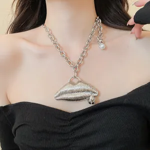 Detailed view of a silver chunky chain necklace with a ribbed 3D lip pendant accessory.
