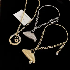 Detailed view of retro textured lip pendant necklaces featuring chunky gold and silver chains.