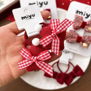 Festive red star hair ties with plush balls and checkered bows for New Year styling
