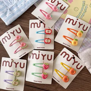 Detail of colorful fruit resin hair clips for girls on branded display cards