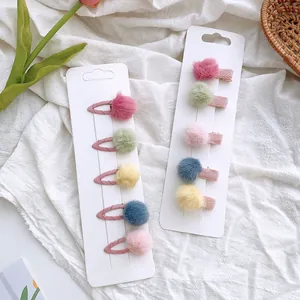 Set of 10 colorful mini pompom hair clips for girls featuring candy colors and soft texture