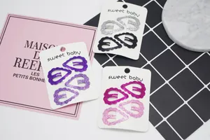Détail de barrettes à paillettes en forme de cœur roses et violettes sur cartes Sweet Baby