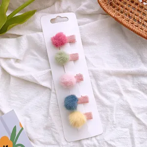 Five-piece set of mini plush pom-pom hair clips in vibrant candy colors for girls