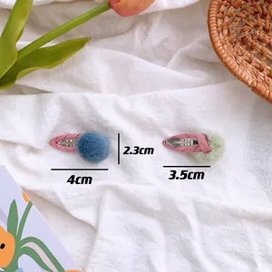 Detail view of 3.5cm and 4cm plush pom pom hair clips with size measurement data