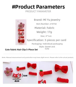 Detailed view of five colorful fabric hair clips for girls with strawberry and bow designs