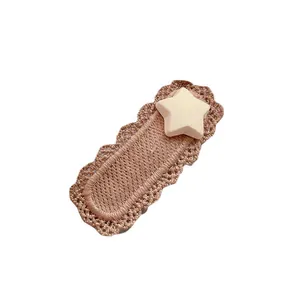 Cute knitted hair clip with star decoration in warm beige tones for girls and toddlers