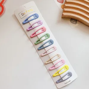 Lot de 10 barrettes BB colorées soigneusement disposées sur une carte de support