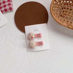Detalle de pinzas para el cabello florales en tarjeta blanca con fondo rústico natural