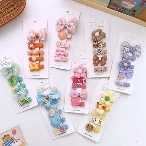 Flat lay of colorful children bow hair clips sets on cards with cute patterns