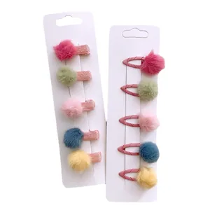 Colorful plush pompom hair clips set for girls featuring 10 mini bows and candy colors