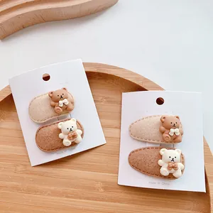 Close-up of cute 3D resin bear hair clips with soft felt texture on display cards