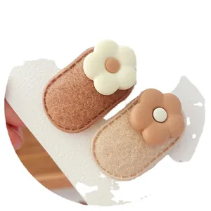 Pair of sweet flower BB hair clips for girls in milk tea brown tones on a white card