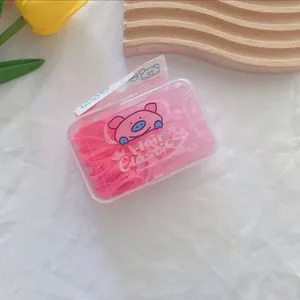 Pink high-elastic hair ties in a cute cartoon box on a stylish decorative setting