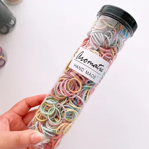 Macro view of colorful elastic hair bands in a transparent container for kids