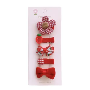 5-piece set of red kids' hair clips featuring bows, flowers, and strawberry patterns