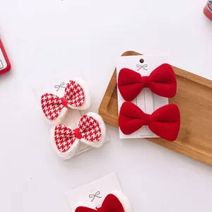 Detail of red velvet and houndstooth bow hair clips for girls on display cards
