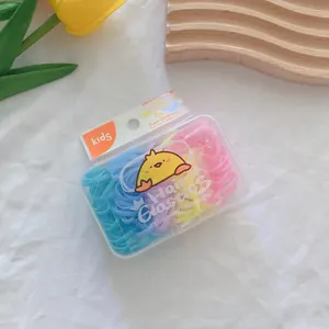 Detail of colorful high elasticity kids hair ties set in a transparent cartoon storage box