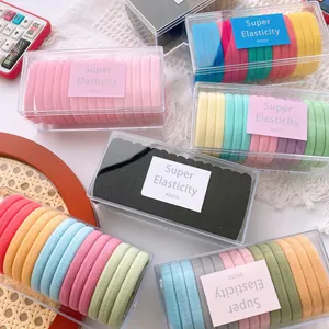 Detailed view of high elasticity seamless hair ties in a clear rectangular storage box