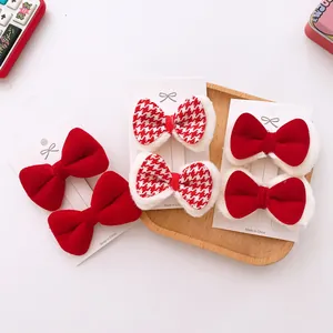 Detailed set of red velvet and houndstooth bow hair clips with white faux fur trim