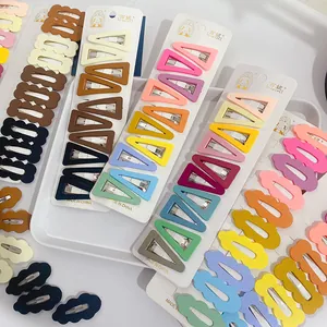 Detailed view of candy-colored matte BB hair clips in wavy and triangular shapes on cards
