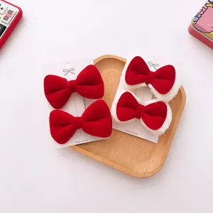 Detail of red velvet and faux fur bow hair clips set for girls on a display card