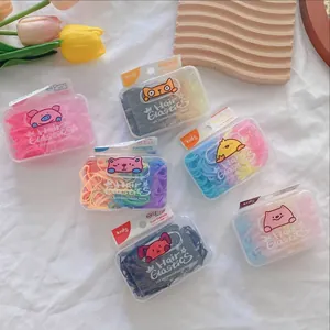 Kids colorful TPU hair elastics in cute animal patterned boxes on a soft white background