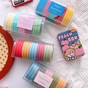 Colorful high elasticity hair bands set in clear cases and a cartoon peach tin box