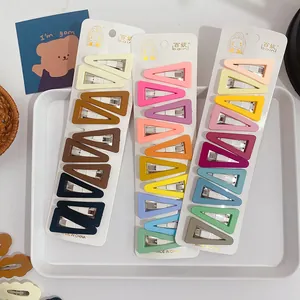Detail of matte triangular snap hair clips in various candy colors on a white display card