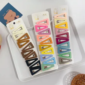 Close-up of matte pastel and earthy tone hair clips set on branded display cards