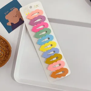 Set of 10 colorful matte wavy snap hair clips displayed on a branded white card