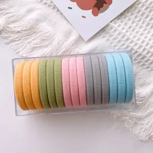 Macro detail of 15 colorful high-elastic hair bands in a transparent storage box