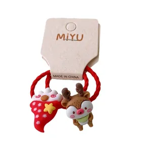 Pair of festive red Christmas hair ties with cute cartoon reindeer and Santa hat charms