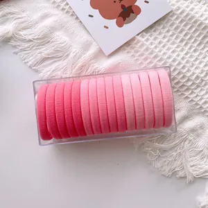 Close-up of 20-piece gradient pink elastic hair ties neatly stored in a clear plastic box