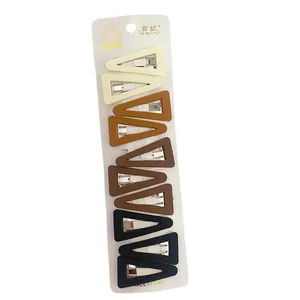 Eight-piece set of geometric triangle matte hair clips in neutral earth tones on white card