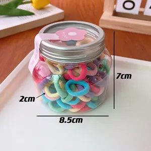Detailed view of candy color hair ties in a clear jar with size markers 2cm and 8.5cm