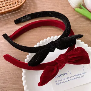 Close-up of handmade velvet bow headbands with hand-made labels in red and black