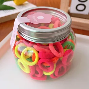 Colorful elastic hair bands for kids in a transparent jar with silver screw cap