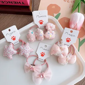 Set of four sweet pink bow hair ties for girls featuring floral and sequin designs
