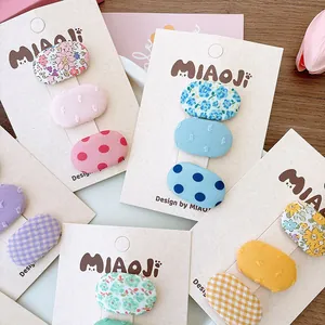 Set di fermagli per capelli in tessuto per bambine con motivi floreali e a pois