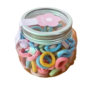 Colorful elastic hair bands in a transparent jar with silver lid for kids