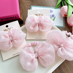 Close-up of pink seersucker bow hair accessories with sparkling silver rhinestones