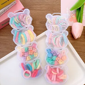 Detail of colorful children hair accessories in cute bear-shaped transparent storage cases