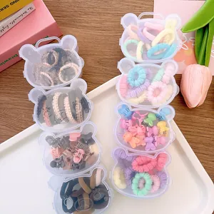 Close-up of bear-shaped storage box with colorful hair accessories and clips